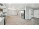 Spacious open-concept living area with modern flooring and views of the kitchen at 3089 S Quintero Way, Aurora, CO 80013