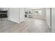 Spacious living room with new gray flooring leading to a modern kitchen with stainless appliances at 3089 S Quintero Way, Aurora, CO 80013