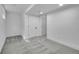 Basement featuring gray carpet, white walls, and multiple doors for access and storage at 1557 S Owens St # 59, Denver, CO 80232