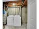 Basement laundry room featuring a water heater, washing machine, and dryer at 1557 S Owens St # 59, Denver, CO 80232