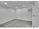 Basement bedroom with gray carpet, white walls, and a basement window at 1557 S Owens St # 59, Denver, CO 80232