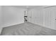 A carpeted bedroom featuring multiple doors for closets and access to other areas of the home at 1557 S Owens St # 59, Denver, CO 80232