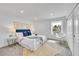 Bright bedroom with white walls, plush carpet, and a comfortable bed with stylish blue accents at 1557 S Owens St # 59, Denver, CO 80232