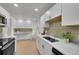 Modern kitchen with white cabinets, stainless steel appliances, and an open design at 1557 S Owens St # 59, Denver, CO 80232