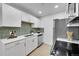 Chic kitchen featuring white cabinetry, stainless steel appliances, and modern fixtures at 1557 S Owens St # 59, Denver, CO 80232