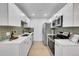 Modern kitchen with white cabinets, stainless steel appliances, and sleek countertops at 1557 S Owens St # 59, Denver, CO 80232