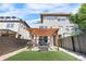 Backyard with pergola-covered patio, complete with seating and grill, alongside a lush artificial turf lawn at 4557 Stuart St, Denver, CO 80212