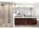 Modern bathroom with double vanity, quartz countertop, and a glass-enclosed shower featuring stylish tile work at 4557 Stuart St, Denver, CO 80212