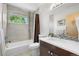 Bathroom with tub-shower combination and a single vanity featuring tile accents and plenty of natural light at 4557 Stuart St, Denver, CO 80212