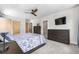 Bedroom boasts a ceiling fan, dresser, and calm, neutral color palette to create a relaxing space at 4557 Stuart St, Denver, CO 80212
