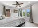 Bright bedroom with a ceiling fan, carpeted floors, and natural light from large windows at 4557 Stuart St, Denver, CO 80212