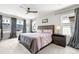Well-lit bedroom showcasing ceiling fan, two side tables with lamps, and large upholstered bed at 4557 Stuart St, Denver, CO 80212