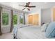 Spacious bedroom featuring a ceiling fan, carpeted floors, and large windows offering scenic views at 4557 Stuart St, Denver, CO 80212