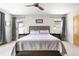 Bright bedroom featuring a ceiling fan, large windows with curtains, and a comfortable upholstered bed at 4557 Stuart St, Denver, CO 80212
