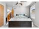 Cozy bedroom with a ceiling fan, carpeted floors, natural light, and stairs leading to the lower level at 4557 Stuart St, Denver, CO 80212