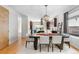 Open dining area with modern table, white chairs, and decorative lighting next to an open kitchen at 4557 Stuart St, Denver, CO 80212