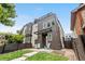 Two-tone modern home featuring a rooftop deck, with a manicured front yard at 4557 Stuart St, Denver, CO 80212