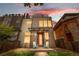 Striking modern home with a metal facade, complemented by an inviting entrance and two chairs at 4557 Stuart St, Denver, CO 80212