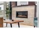 Modern fireplace featuring a stone surround, a dark mantle, and an electric firebox at 4557 Stuart St, Denver, CO 80212