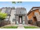 Modern home with a two-tone exterior, covered porch, and rooftop deck at 4557 Stuart St, Denver, CO 80212