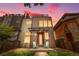 Modern home with a two-tone exterior, covered porch, and rooftop deck at dusk at 4557 Stuart St, Denver, CO 80212