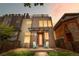 Modern home with a two-tone exterior, covered porch, and rooftop deck with sunset at 4557 Stuart St, Denver, CO 80212