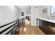 Bright hallway featuring hardwood floors, wet bar with modern cabinetry, and natural light from the living room at 4557 Stuart St, Denver, CO 80212