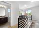 Hallway leading to a patio and a bathroom with hardwood floors and a metal railing at 4557 Stuart St, Denver, CO 80212