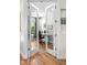 Open office with glass paneled doors, a view to the outside, modern desk, and hardwood floors at 4557 Stuart St, Denver, CO 80212