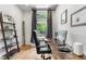 Bright home office featuring a modern desk, comfortable chair, and ample natural light from the window at 4557 Stuart St, Denver, CO 80212