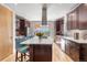Modern kitchen boasts a large island with seating, stainless steel appliances, and view to the backyard at 4557 Stuart St, Denver, CO 80212