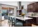 Modern kitchen features a large island with seating, stainless steel appliances, and view to the backyard at 4557 Stuart St, Denver, CO 80212