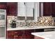 Contemporary kitchen features sleek countertops, stylish backsplash, modern fixtures, and stainless steel appliances at 4557 Stuart St, Denver, CO 80212