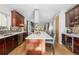 Spacious kitchen featuring stainless steel appliances, an island with seating, and modern fixtures at 4557 Stuart St, Denver, CO 80212