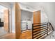 Upper level laundry room with modern side-by-side washer and dryer units, and hardwood floors at 4557 Stuart St, Denver, CO 80212