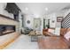 Inviting living room with a modern fireplace, wood floors, and a comfortable seating area at 4557 Stuart St, Denver, CO 80212