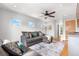 Inviting living room showcasing a plush sofa, ceiling fan, recessed lighting, and a view to the hallway at 4557 Stuart St, Denver, CO 80212