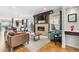 Open-concept living room featuring a stone fireplace, hardwood floors, and plenty of natural light at 4557 Stuart St, Denver, CO 80212