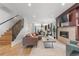 Open-concept living space featuring a modern fireplace, wood floors, and a staircase at 4557 Stuart St, Denver, CO 80212