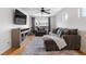 Comfortable living room featuring a large sofa, fireplace, ceiling fan, and ample natural light from the large window at 4557 Stuart St, Denver, CO 80212