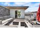 Stylish rooftop patio featuring comfortable seating, a fire pit, and seamless indoor-outdoor living through sliding glass doors at 4557 Stuart St, Denver, CO 80212