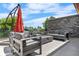 Inviting outdoor patio with comfortable seating, a stone accent wall, and an umbrella for shade on sunny days at 4557 Stuart St, Denver, CO 80212