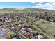 Scenic aerial view of a residential neighborhood nestled among rolling hills, with mature trees at 2194 S Braun Way, Lakewood, CO 80228