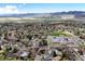 Stunning aerial of community near mountains, showcasing homes, schools, and recreational areas at 2194 S Braun Way, Lakewood, CO 80228