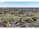 Scenic aerial view of a neighborhood with rolling hills, trees, and city skyline in distance at 2194 S Braun Way, Lakewood, CO 80228
