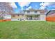The spacious backyard offers a well-maintained lawn and covered patio perfect for relaxing and outdoor activities at 2194 S Braun Way, Lakewood, CO 80228