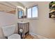 Charming half bath features wood-style vanity, modern fixtures, and decorative accents at 2194 S Braun Way, Lakewood, CO 80228
