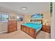 This serene main bedroom features warm wood furniture, soft lighting, and bright accents for a comfortable retreat at 2194 S Braun Way, Lakewood, CO 80228