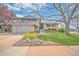 Charming two-story home with a well-manicured lawn, mature trees, and an attached two-car garage at 2194 S Braun Way, Lakewood, CO 80228