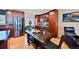 Cozy kitchen with a dining area, stainless steel refrigerator, wooden table, and modern updates at 2194 S Braun Way, Lakewood, CO 80228